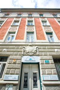 a tall building with a sign on the front of it at Haus Mobene - Hotel Garni in Graz