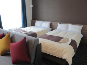 Rúm í herbergi á Henn na Hotel Laguna Ten Bosch