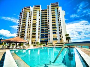 a large apartment building with a large swimming pool at 440 West Condo 1604N in Clearwater Beach