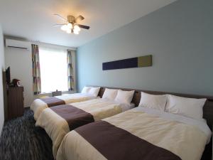 Rúm í herbergi á Henn na Hotel Laguna Ten Bosch