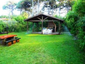 a gazebo with a table and chairs in a yard at Casas De Pinamar in Pinamar