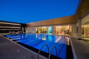 a large swimming pool in a building at night at Braira Qurtubah in Riyadh