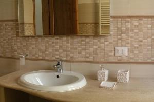 a bathroom with a sink and a mirror at Casa Elena in Dorgali