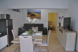 a living room with a dining table and a kitchen at Mogan Sol in Puerto de Mogán