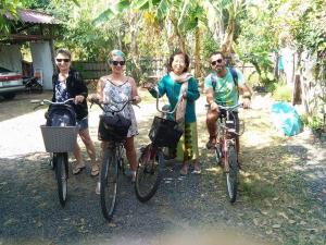 a group of people posing with their bikes at Rim Than View Resort in Ubon Ratchathani +69 photos