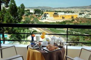 a table with a plate of food on top of a balcony at Menzeh Zalagh 2Boutique Hôtel & Sky in Fez