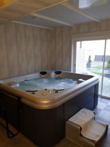 a large bath tub in a room with a window at Bubble Dreams in Coupéville