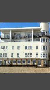 a large white building with balconies on top of it at Beachview Apartment in Edinburgh