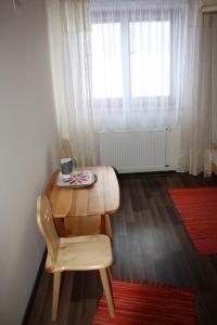 a wooden table and chair in a room with a window at Zawojska Przystań in Zawoja