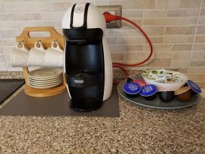 a coffee maker sitting on a counter next to a plate at B&B Buscemi in Pistoia
