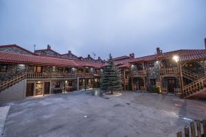 a christmas tree in the courtyard of a building at Hotels Voras in Palaios Agios Athanasios