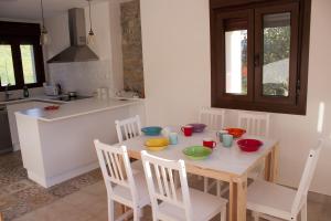 a kitchen with a wooden table with bowls on it at La Panera del Carbain in Soto del Barco