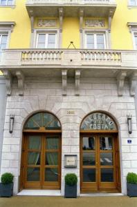 a building with two doors and a balcony on top at Albergo Alla Posta in Trieste