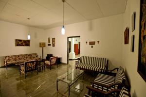 a living room with chairs and a couch and a table at HOSTEL KATUNAYAKE At COLOMBO AIRPORT TRANSIT in Katunayake