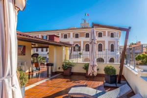 un balcone con ombrelloni di fronte a un edificio di Relais Trevi 95 Boutique Hotel a Roma