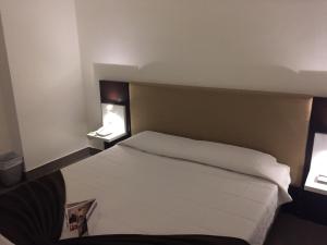 Łóżko lub łóżka w pokoju w obiekcie LH Hotel Excel Roma Montemario