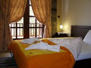 PanayítsaにあるGuesthouse Naoumaのタオルが敷かれたベッドのある寝室