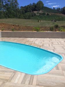 a large blue swimming pool on a patio at Pousada Terra Nossa in Santa Maria