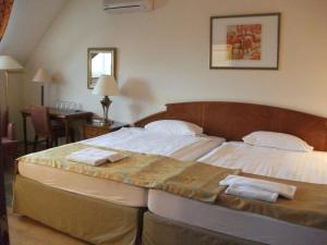 Postel nebo postele na pokoji v ubytování Hotel Rittinger