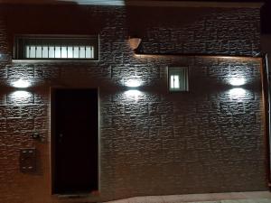 un muro di mattoni con due finestre e una porta di La Casetta a Leporano
