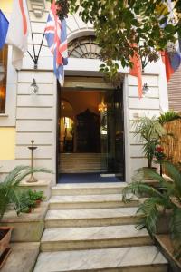 a staircase leading to a building with flags on it at Hotel Silva in Rome