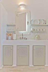 a bathroom with a sink and a mirror at Lux View Villas in Kyra Panagia