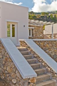 a stone staircase in front of a white house at Lux View Villas in Kyra Panagia
