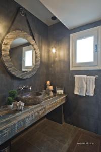a bathroom with a sink and a mirror at Lux View Villas in Kyra Panagia