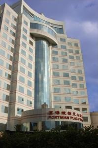 a large building with a sign in front of it at Ningbo Portman Plaza Hotel in Ningbo
