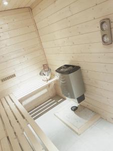 an inside of a sauna with a trash can at Evasion Tonique in Villers-le-Lac