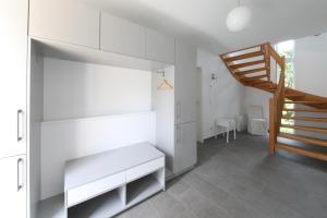 a white room with white shelves and a staircase at Ferienhaus Caputh in Caputh