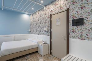 a small bedroom with a bed and a door at Hotel Palace in Battipaglia