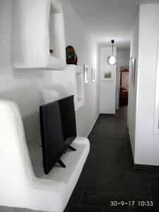 Televizors / izklaižu centrs naktsmītnē Apartamento Faro Sardina