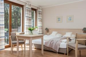 Łóżko lub łóżka w pokoju w obiekcie Villa Sosnowa