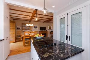 a kitchen with a counter top and a stove top oven at 271 - La Victorienne - Les Immeubles Charlevoix in Baie-Saint-Paul