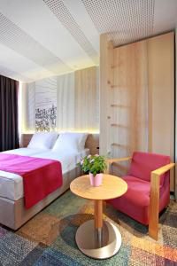 Postel nebo postele na pokoji v ubytování Hotel Cosmopolit