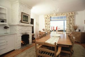 a dining room with a table and a fireplace at 241 - La Côte Fleurie - Les Immeubles Charlevoix in La Malbaie