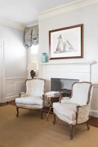a living room with two chairs and a table at Zero George Hotel in Charleston