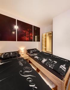two beds sitting next to each other in a bedroom at Apartments Postic in Osijek