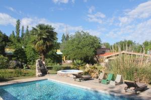 a swimming pool with lounge chairs and a swimming pool at La Casa de Wanda in Villa Las Rosas