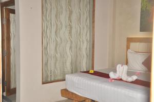 Posteľ alebo postele v izbe v ubytovaní Crystal Beach Bali