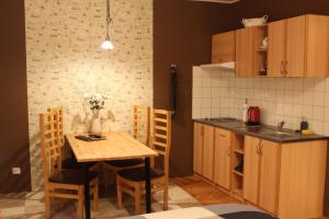 a kitchen with a wooden table and a small table and chairs at Ubytování U Morisse in Staré Město