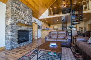 a living room with a couch and a fireplace at Eagle's Nest- A pet friendly cabin on the river! in Luray
