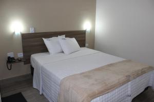 Postel nebo postele na pokoji v ubytování Hotel Infinity