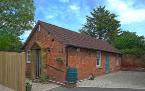 a brick building with a trash can in front of it at Rose cottage in Wellington