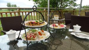 a table with three plates of food on it at Argent Motor Lodge in Hamilton