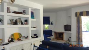 アルブフェイラにあるBalaia Luxury Apartmentのリビングルーム(青いソファ、暖炉付)