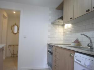 a kitchen with a sink and a stove at Casa Zé Bonito I in Cascais