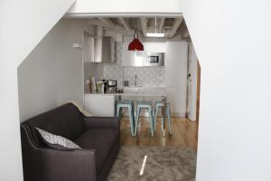 a living room with a couch and a kitchen at Augusta Street 213 - 4 Dto in Lisbon