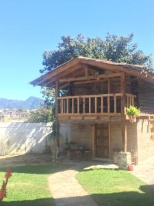 a large wooden building with a table in a yard at Xamikal in Zacatlán